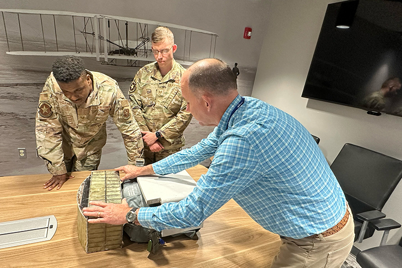 airmen pushing a missile in warehouse